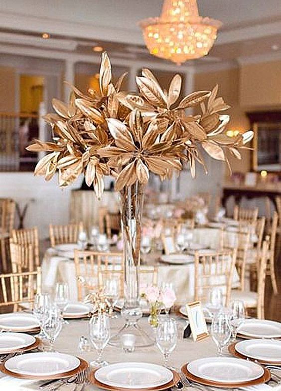tall, gilded flower centerpieces arranged on wedding reception table