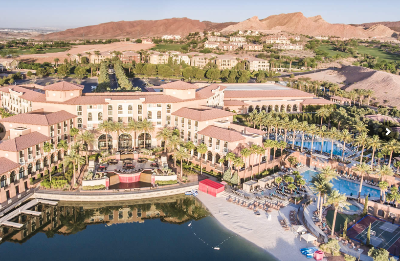 a small beach, kayaks, pool, and water of lake las vegas bordering the westin hotel