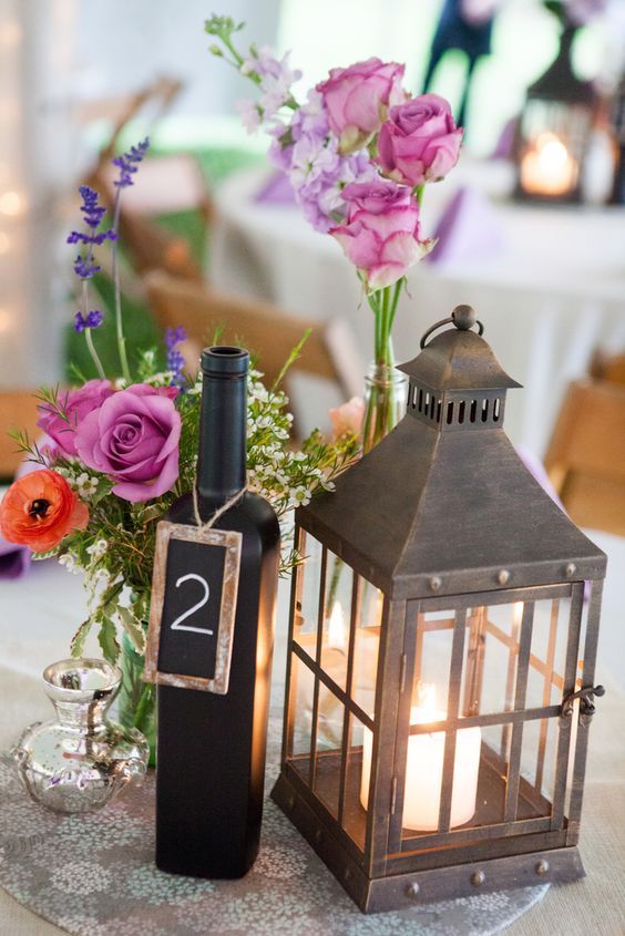 lantern and flowers arranged on a wedding reception table