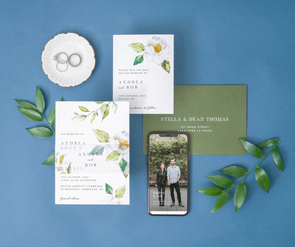 Wedding invitation guide photo featuring Joy's white garden theme with a save the date, wedding website and envelope