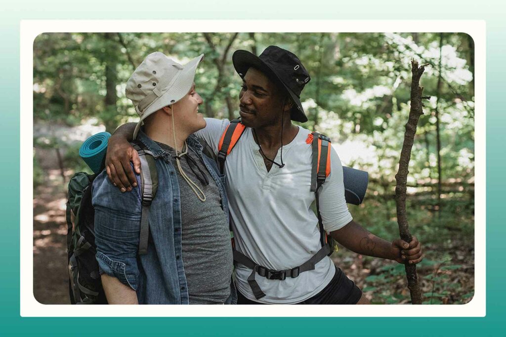 A happy couple hiking in the woods