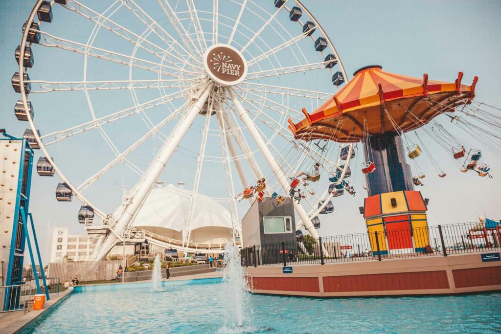 The Navy Pier in Chicago featuring a Ferris wheel and swing amusement ride