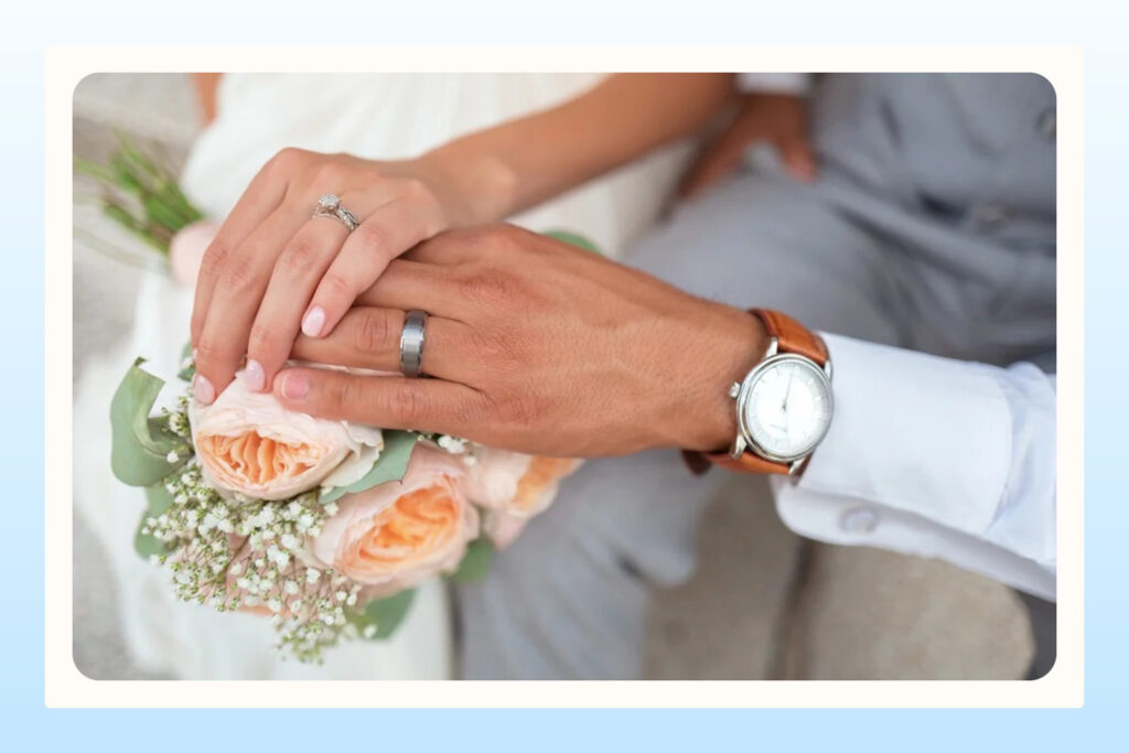 Hands of a married couple wearing wedding rings