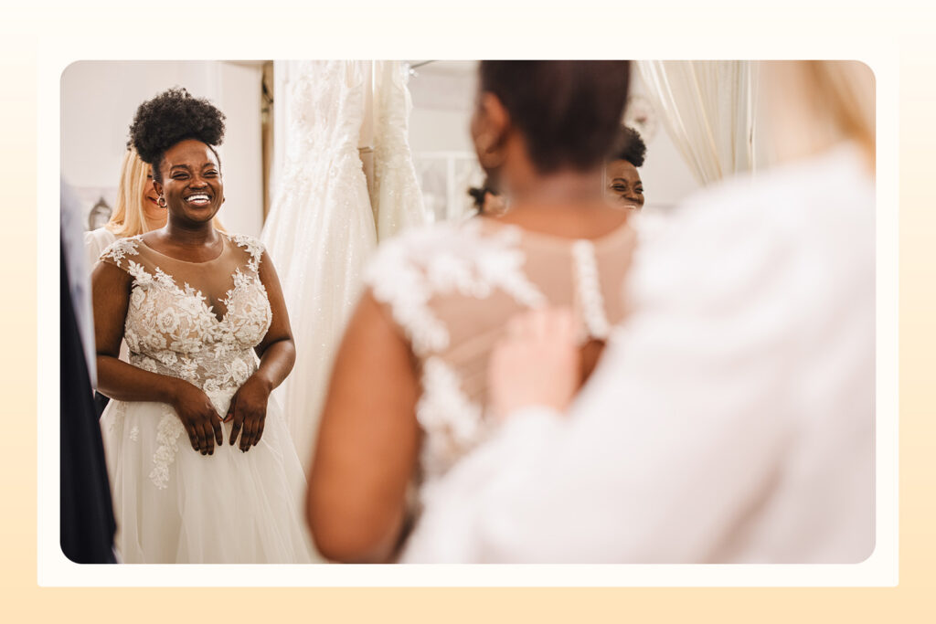 woman trying on wedding dress in a fitting room