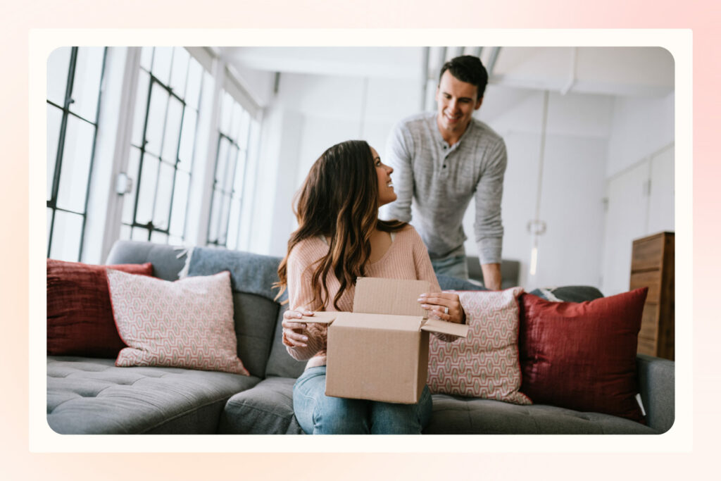 couple discussing wedding registry items together in their living room