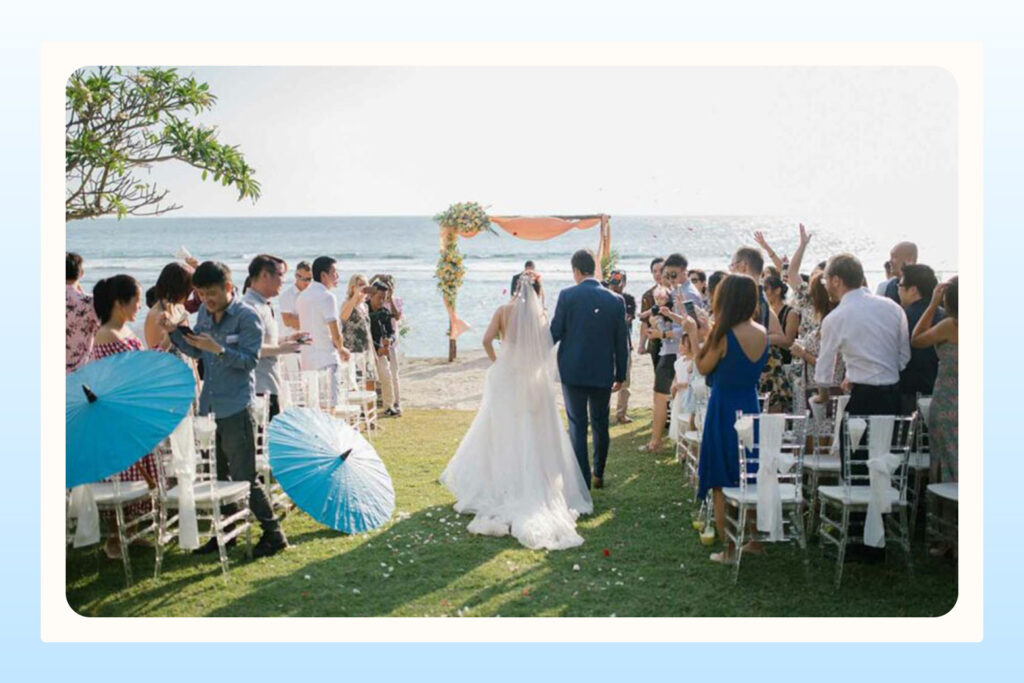 couple walking down the aisle of their beachside wedding
